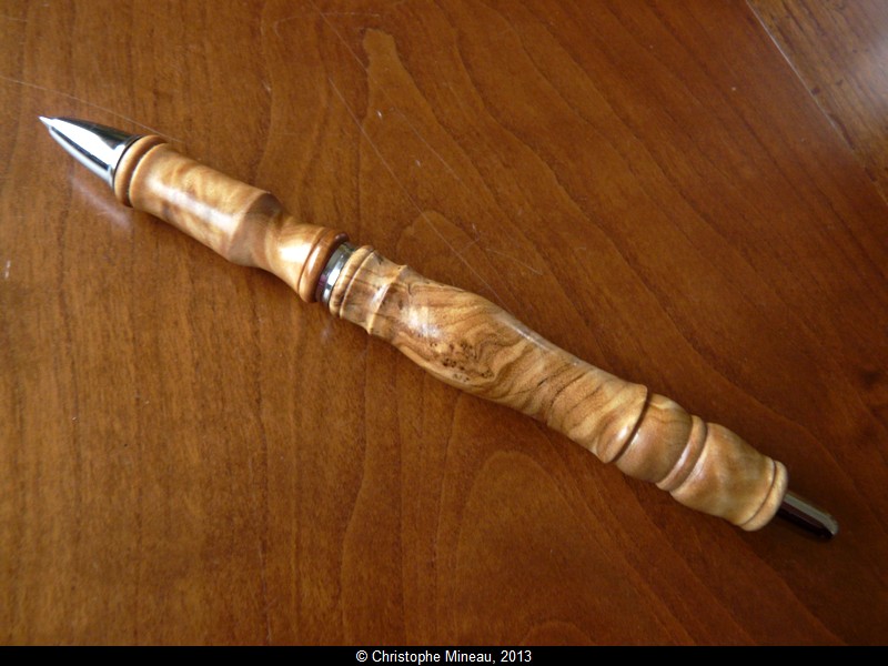 Roller pencil, made of highly figured olive wood.