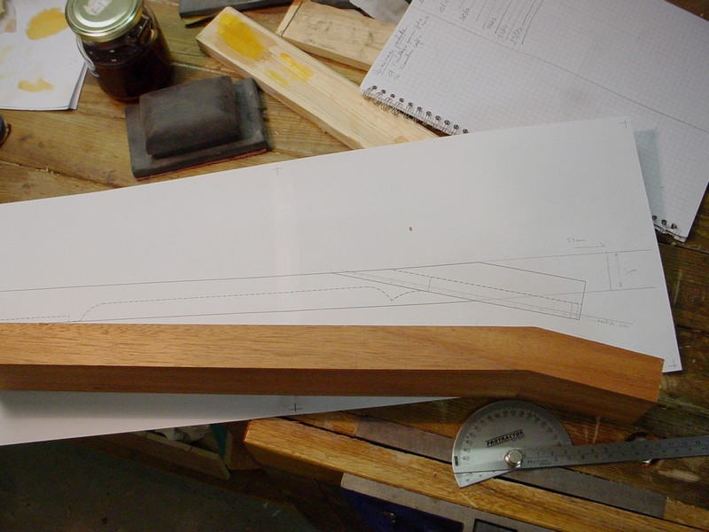 Dry fit. The bevel is below the fingerboard.