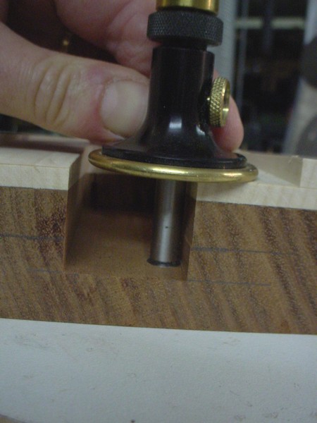 Setting the depth of the tenon using the gauge in the mortize.