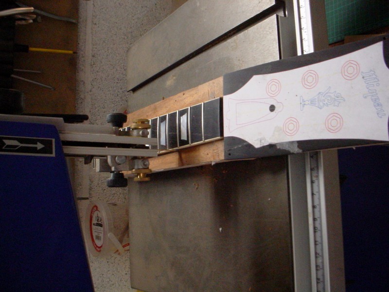 After the fingerboard is glued, cut of the sides of the nek and headplate..