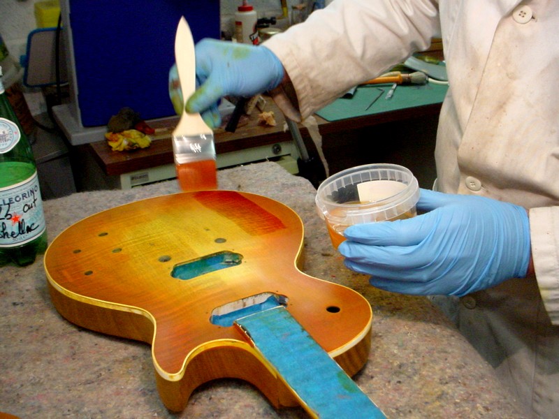 Isolation the dye with a layer of shellac. Important, even an alcohol based dye will flow with the waterborne lacquer.