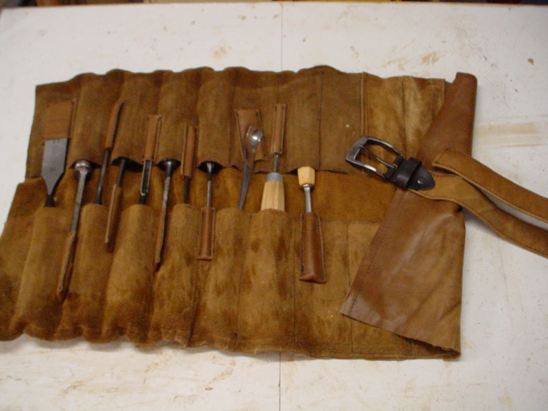 A leather tool roll for my carving gouges. Leather salvaged from an old sofa.