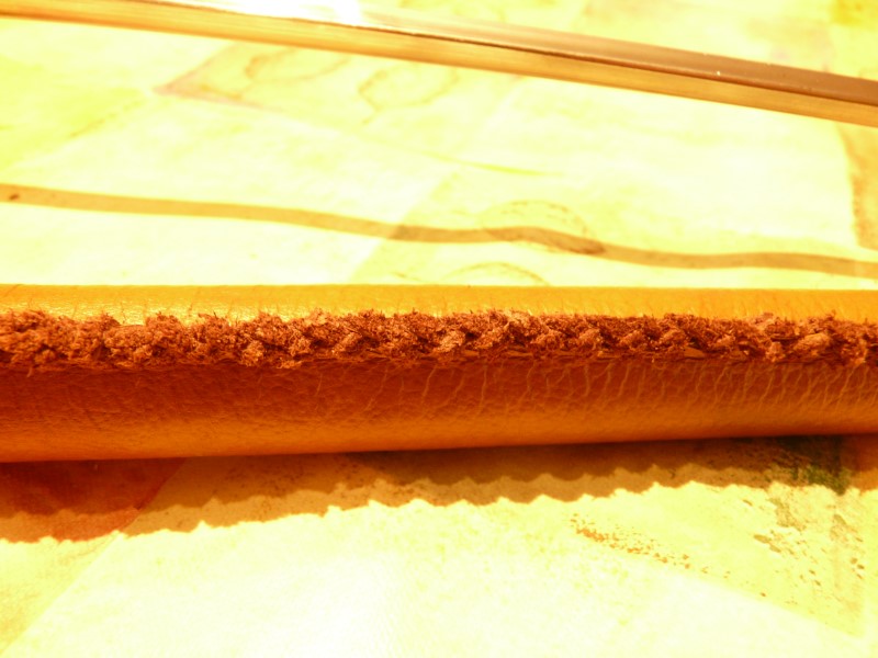 The body is made out of a piece of hosepipe. I covered it with nice leather, laced using the double loop stitch.