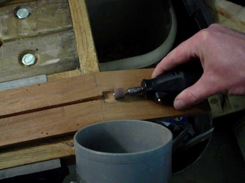 The nut pocket. Using a little sanding cylinder on the Dremel.