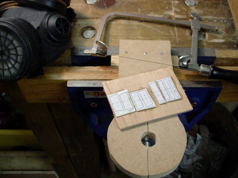 The inlay  shapes are cut from a printout of the plan. They are glued onto MOP pieces, which are glued on to 3mm plywood.