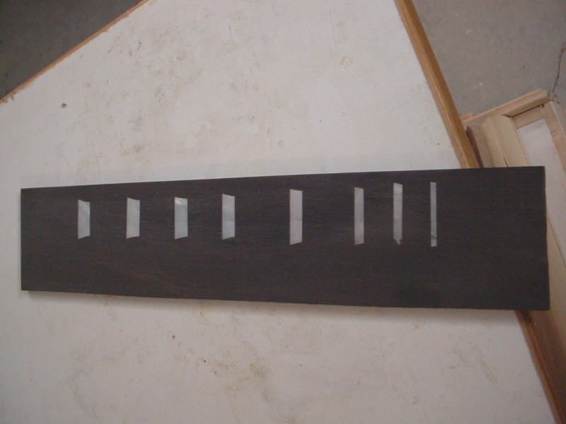 And I sand flush. It is done before the fret slots cutting, in order to avoid clogging them.