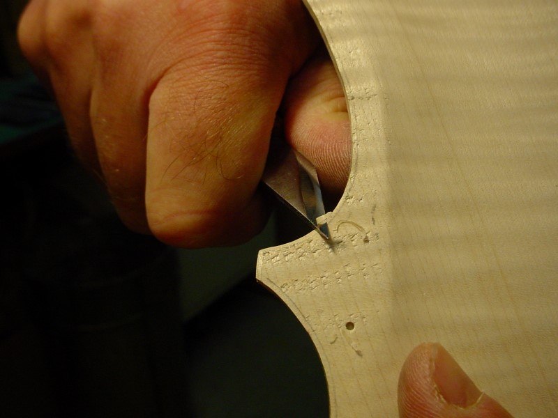 Drafting the rounded edge cutting a straight chanfer with the knife.