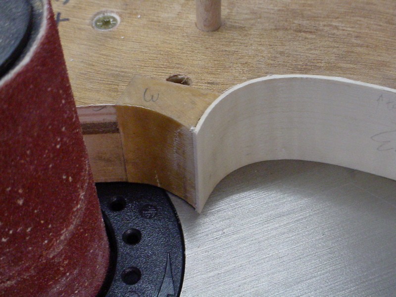 Adjusting the corner angle with the spindle sander.