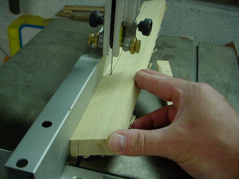 Sawing parallel to the wood grain.