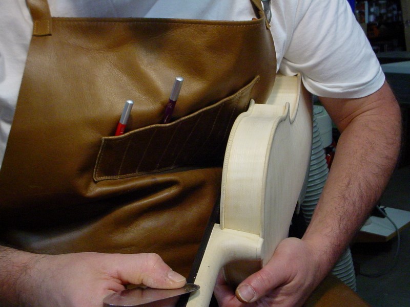 Adjusting the sides of the neck to the fingerboard.